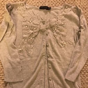 Darling  cardigan with lace bow and pearl details!